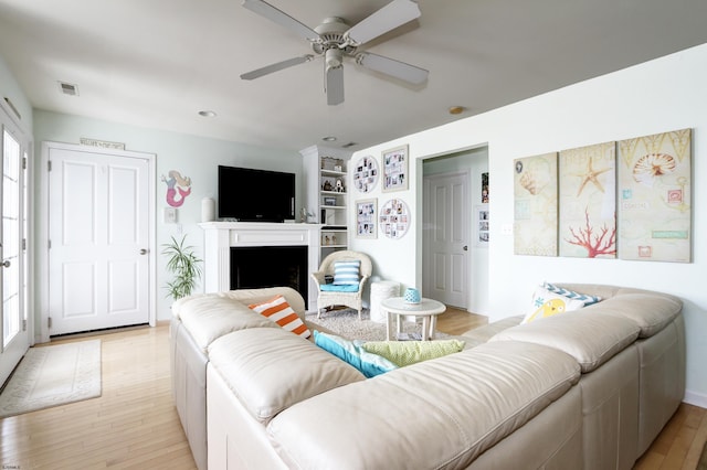 818 Aldrich Rd Fl 2Nd, Ocean City, NJ 08226 - living room featuring light wood finished floors, a ceiling fan, built in features, and a fireplace