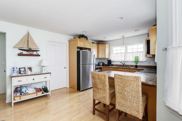 818 Aldrich Rd Fl 2Nd, Ocean City, NJ 08226 - kitchen with a sink, freestanding refrigerator, light wood finished floors, a kitchen breakfast bar, and pendant lighting