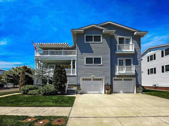 818 Aldrich Rd Fl 2Nd, Ocean City, NJ 08226 - view of front of property featuring a balcony, a garage, concrete driveway, and a front lawn