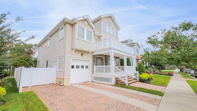 13 S Vendome Ave, Margate, NJ 08402 - townhome / multi-family property featuring a balcony, an attached garage, fence, covered porch, and decorative driveway
