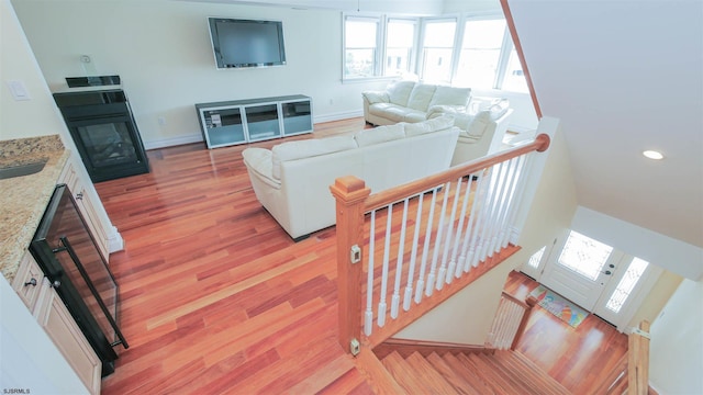 13 S Vendome Ave, Margate, NJ 08402 - living area featuring light wood finished floors, baseboards, a glass covered fireplace, and recessed lighting