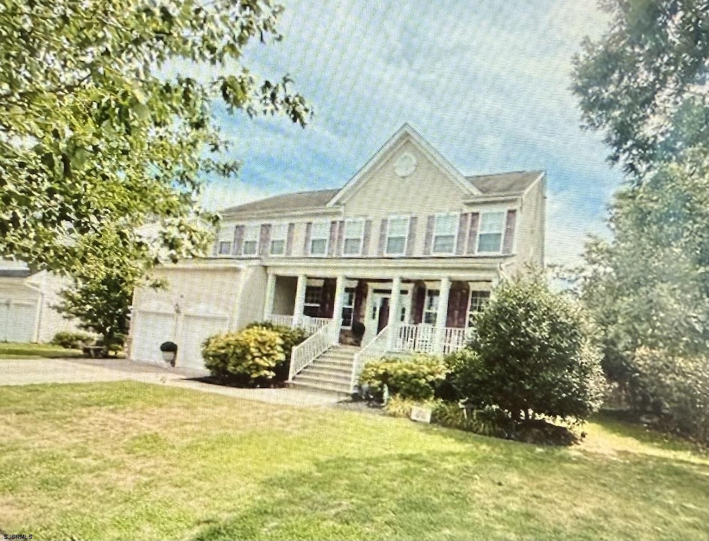 127 Rockport, Egg Harbor Township, NJ 08234 - view of front of house with covered porch, a front yard, driveway, and a garage
