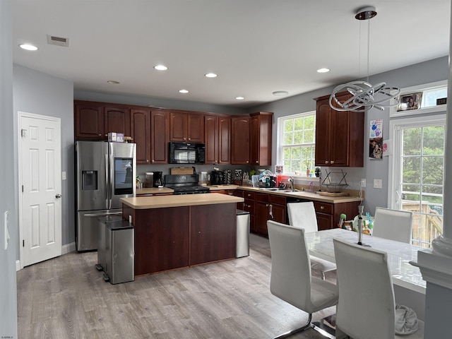 127 Rockport, Egg Harbor Township, NJ 08234 - kitchen featuring black appliances, light countertops, light wood finished floors, a kitchen island, and a chandelier