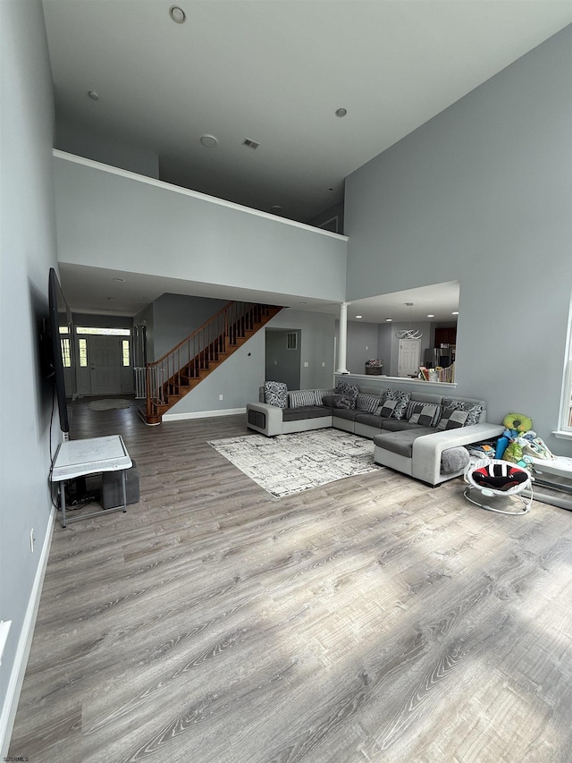 127 Rockport, Egg Harbor Township, NJ 08234 - living room with a towering ceiling, stairs, wood finished floors, and baseboards