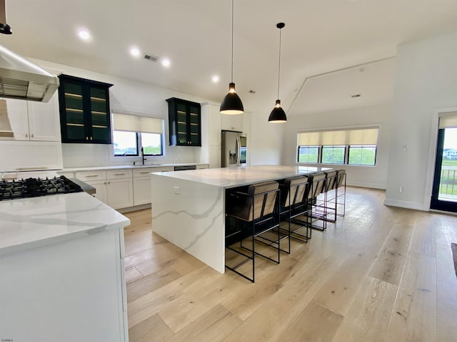 116 Bayshore Ave, Brigantine, NJ 08203 - kitchen featuring stainless steel fridge, a sink, a spacious island, range hood, and light wood-style floors