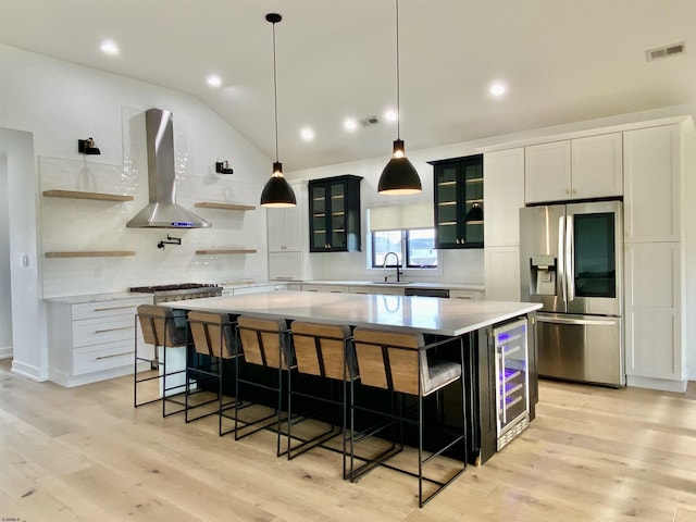 116 Bayshore Ave, Brigantine, NJ 08203 - kitchen with stainless steel refrigerator with ice dispenser, wall chimney exhaust hood, a sink, a spacious island, and open shelves