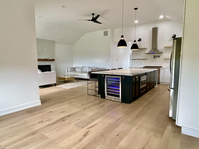 116 Bayshore Ave, Brigantine, NJ 08203 - kitchen with island range hood, beverage cooler, appliances with stainless steel finishes, vaulted ceiling, and ceiling fan