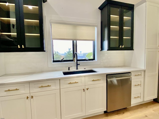 116 Bayshore Ave, Brigantine, NJ 08203 - kitchen featuring stainless steel dishwasher, a sink, glass insert cabinets, and tasteful backsplash