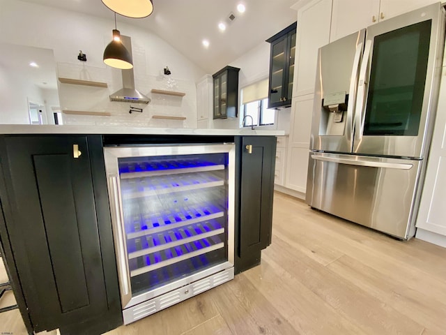 116 Bayshore Ave, Brigantine, NJ 08203 - kitchen featuring stainless steel refrigerator with ice dispenser, wine cooler, light countertops, lofted ceiling, and light wood finished floors