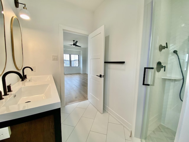 116 Bayshore Ave, Brigantine, NJ 08203 - bathroom with double vanity, a shower stall, ceiling fan, tile patterned flooring, and baseboards