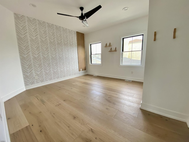 116 Bayshore Ave, Brigantine, NJ 08203 - spare room with wallpapered walls, baseboards, a ceiling fan, an accent wall, and light wood finished floors
