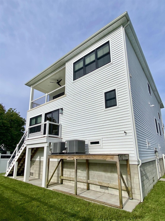 116 Bayshore Ave, Brigantine, NJ 08203 - rear view of property with central AC, a balcony, a ceiling fan, a lawn, and stairs