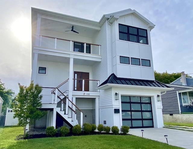 116 Bayshore Ave, Brigantine, NJ 08203 - view of front of property featuring an attached garage, a standing seam roof, concrete driveway, stairs, and a balcony