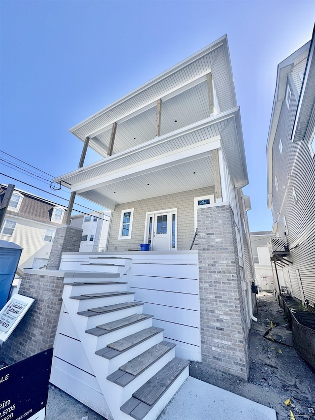 308 13th St, Ocean City, NJ 08226 - view of front of home with stairs, a porch, and brick siding