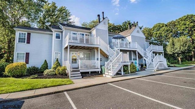 235 London Ct Unit 235, Egg Harbor Township, NJ 08234 - rear view of property featuring uncovered parking, stairs, and a balcony