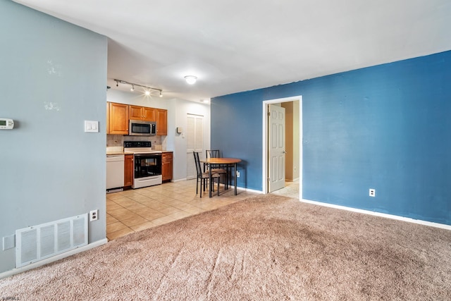 235 London Ct Unit 235, Egg Harbor Township, NJ 08234 - living room with light colored carpet, light tile patterned floors, baseboards, and track lighting