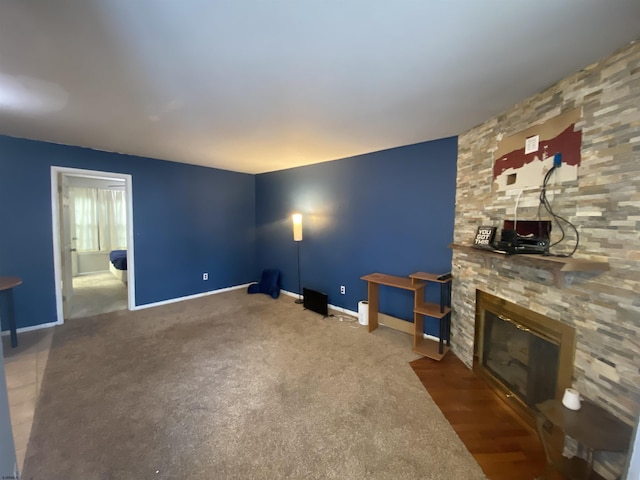 235 London Ct Unit 235, Egg Harbor Township, NJ 08234 - unfurnished living room with a stone fireplace, baseboards, and carpet floors
