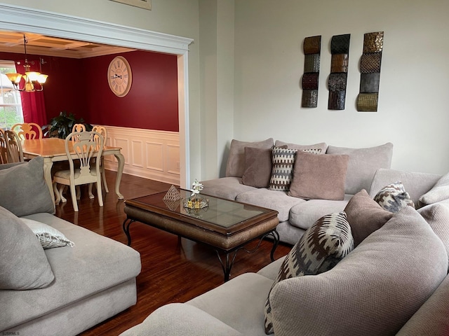 living room featuring a chandelier, wood finished floors, and wainscoting
