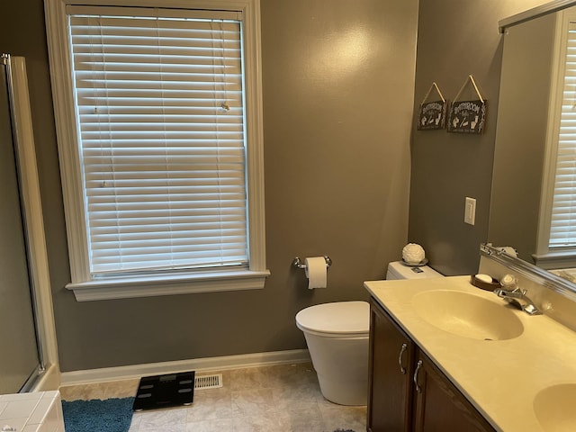 full bathroom featuring baseboards, double vanity, toilet, a shower with door, and tile patterned flooring