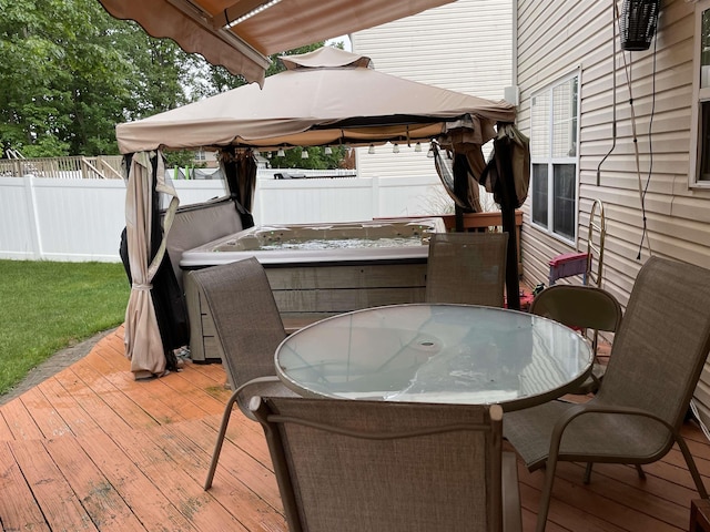 deck with a fenced backyard, a gazebo, and outdoor dining space