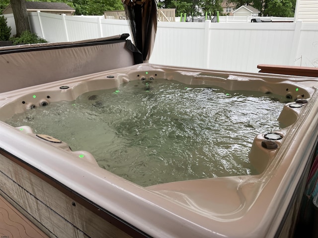 exterior view of a hot tub and fence