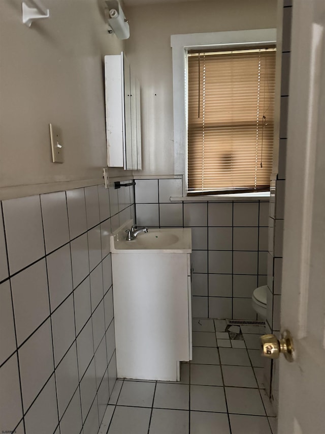 224 Linden Ave, Pleasantville, NJ 08232 - bathroom with tile walls, tile patterned flooring, toilet, vanity, and a wainscoted wall