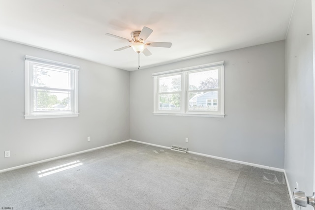 unfurnished room featuring ceiling fan, carpet, and baseboards