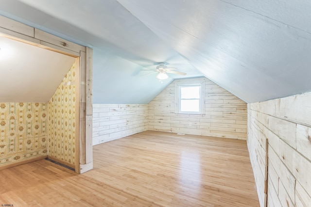 bonus room with wood finished floors, ceiling fan, and lofted ceiling