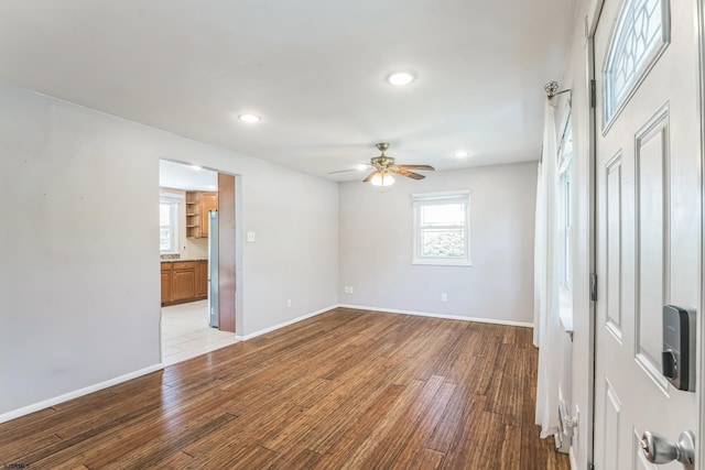 spare room featuring wood finished floors, recessed lighting, a ceiling fan, and baseboards