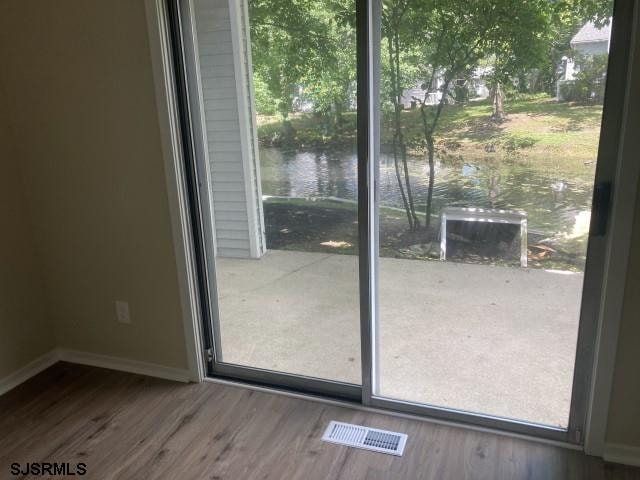 120 Heathercroft Unit 120, Egg Harbor Township, NJ 08234 - entryway featuring a water view, wood finished floors, and baseboards