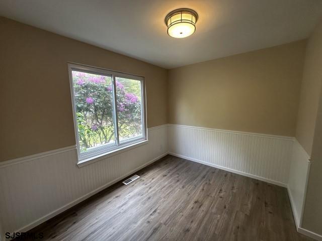 120 Heathercroft Unit 120, Egg Harbor Township, NJ 08234 - spare room with wainscoting and wood finished floors