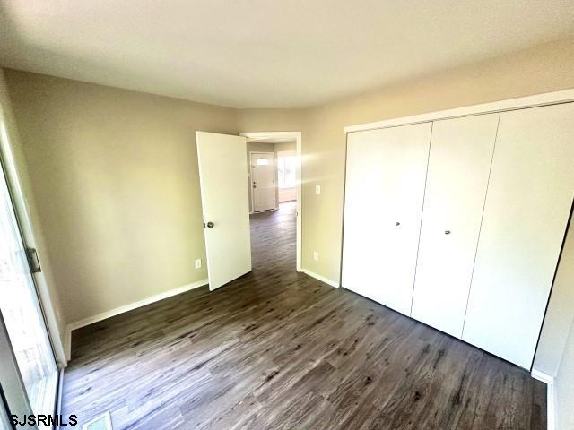 120 Heathercroft Unit 120, Egg Harbor Township, NJ 08234 - unfurnished bedroom with dark wood-style floors, a closet, and baseboards