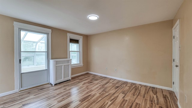 25 N Aberdeen Pl, Atlantic City, NJ 08401 - spare room featuring light wood finished floors, baseboards, plenty of natural light, and radiator heating unit
