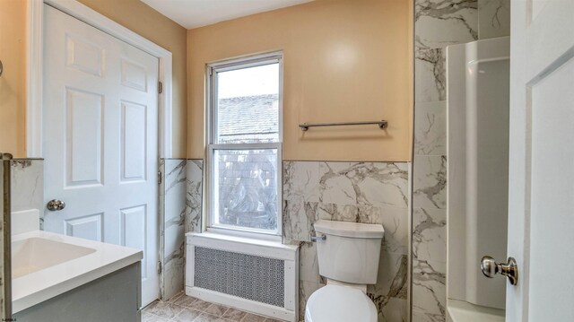 25 N Aberdeen Pl, Atlantic City, NJ 08401 - full bathroom with radiator, tile walls, toilet, vanity, and a wainscoted wall