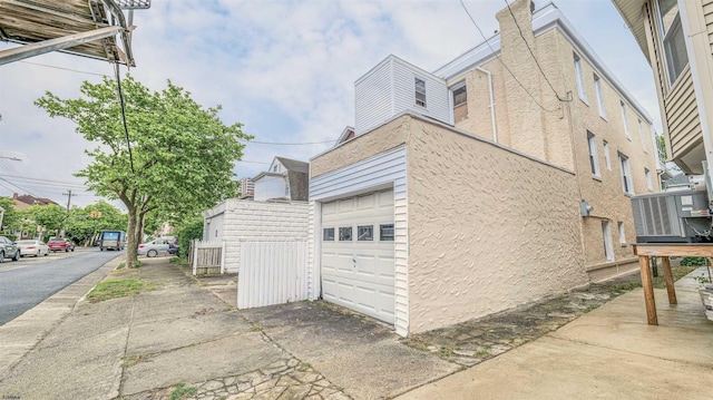 25 N Aberdeen Pl, Atlantic City, NJ 08401 - view of home's exterior with a chimney, a garage, and stucco siding