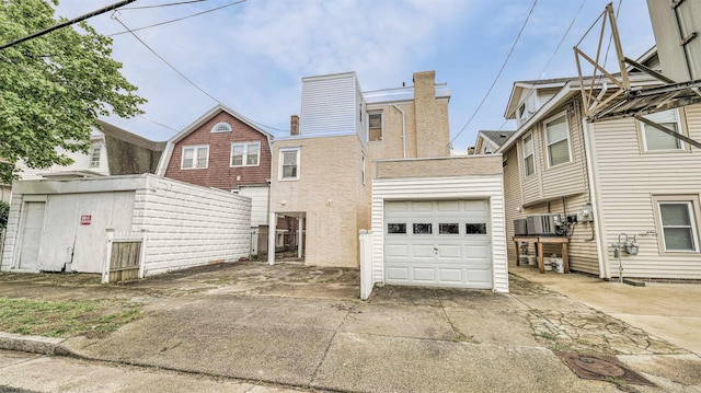 25 N Aberdeen Pl, Atlantic City, NJ 08401 - rear view of house featuring a garage, driveway, and a chimney