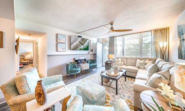 500 Bay Ave Unit 406S, Ocean City, NJ 08226 - living area featuring a textured ceiling, a ceiling fan, wood finished floors, and wainscoting