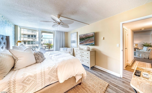 500 Bay Ave Unit 406S, Ocean City, NJ 08226 - bedroom with light wood-type flooring, baseboards, a textured ceiling, and a ceiling fan