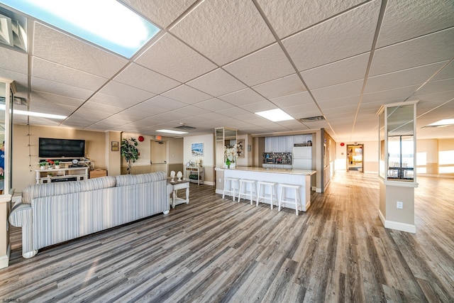 500 Bay Ave Unit 406S, Ocean City, NJ 08226 - living room featuring wood finished floors, baseboards, and a drop ceiling