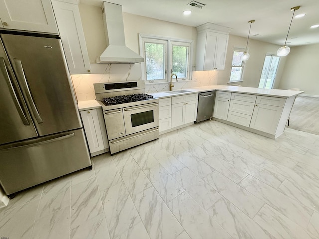 25 Wilson, Northfield, NJ 08225 - kitchen featuring appliances with stainless steel finishes, wall chimney exhaust hood, light marble finish floors, light countertops, and a peninsula