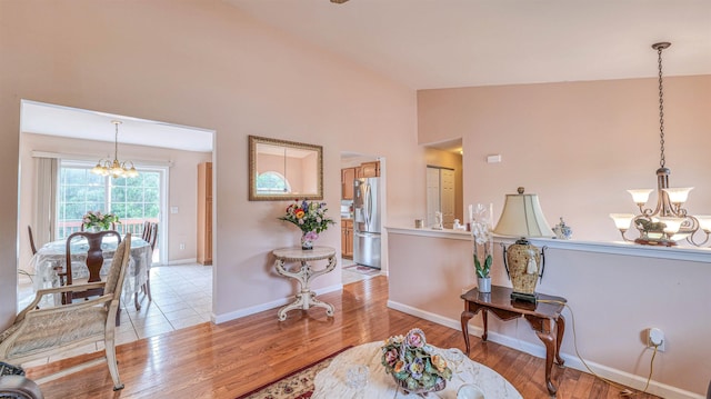 921 Navajo Ave, Absecon, NJ 08201 - interior space with a chandelier, wood finished floors, lofted ceiling, and baseboards