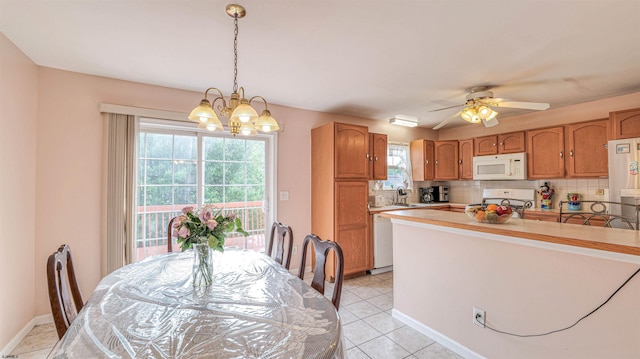 921 Navajo Ave, Absecon, NJ 08201 - kitchen featuring white appliances, light countertops, a chandelier, decorative backsplash, and decorative light fixtures