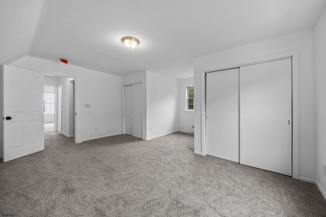 414A Upas Ave, Galloway Township, NJ 08205 - unfurnished bedroom with multiple closets, carpet flooring, and multiple windows