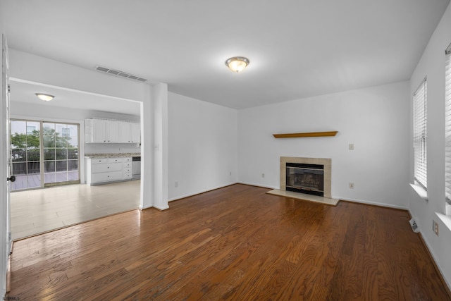 414A Upas Ave, Galloway Township, NJ 08205 - unfurnished living room with wood finished floors, a tiled fireplace, and baseboards