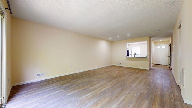 156 Rumson Dr Unit 156, Galloway Township, NJ 08205 - spare room featuring light wood-style flooring, a textured ceiling, recessed lighting, baseboards, and a sink