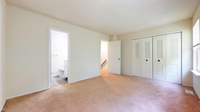 156 Rumson Dr Unit 156, Galloway Township, NJ 08205 - unfurnished bedroom with carpet flooring, a closet, ensuite bathroom, a textured ceiling, and baseboards