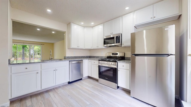 156 Rumson Dr Unit 156, Galloway Township, NJ 08205 - kitchen with stainless steel appliances, a sink, recessed lighting, light wood-style flooring, and light stone counters