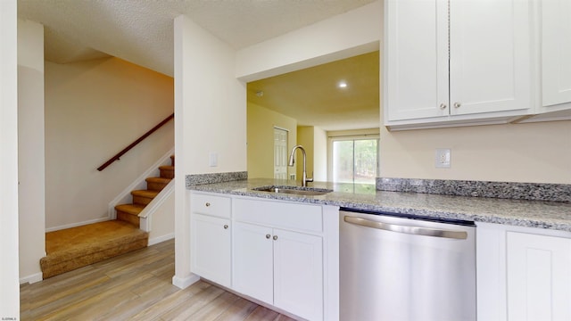 156 Rumson Dr Unit 156, Galloway Township, NJ 08205 - kitchen featuring stainless steel dishwasher, a sink, light wood-style flooring, light stone counters, and white cabinetry