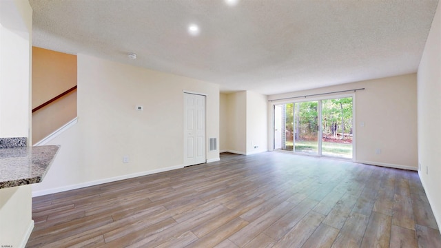 156 Rumson Dr Unit 156, Galloway Township, NJ 08205 - unfurnished living room featuring wood finished floors, baseboards, stairway, recessed lighting, and a textured ceiling
