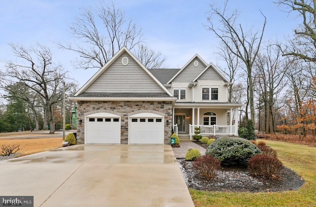 922 Central Ave, Hammonton, NJ 08037 - view of front facade featuring a porch, driveway, stone siding, an attached garage, and board and batten siding